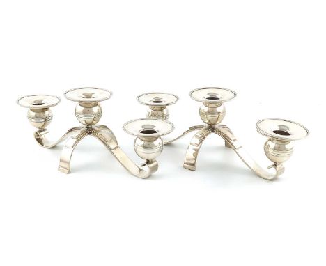 A pair of silver three-light candelabra,by Mappin and Webb, Sheffield 1947,with two scroll arms each supporting a plain capit