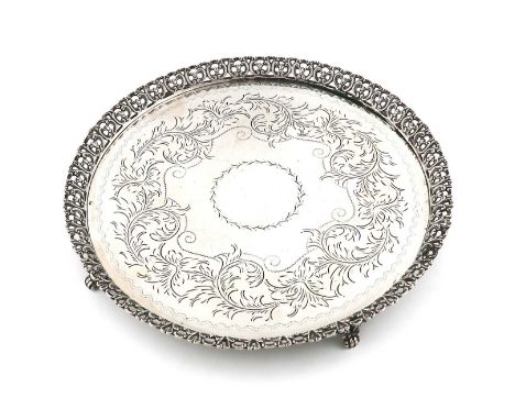 A Brazilian metalware salver,marked Prata 835,circular form, engraved decoration, pierced foliate scroll border, on four foli