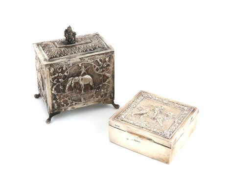 An Indian metalware tea caddy,unmarked,rectangular form, chased with elephants and foliate decoration, the hinged cover with 