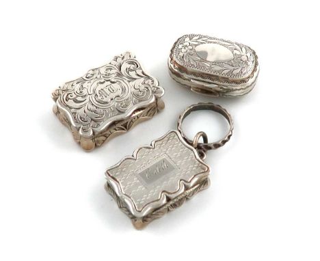 A small collection of three antique silver vinaigrettes, comprising: a Victorian one by Edward Smith, Birmingham 1860, rectan