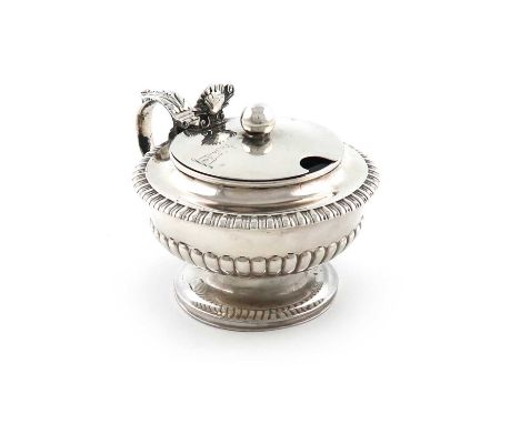 A George III silver mustard pot, by Paul Storr, London 1819, circular form, part-fluted decoration, leaf-capped scroll handle