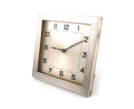 A silver clock,by Charles Perry &amp; Co., Chester 1929,square form, engine-turned decoration, wire-work strut back, height 1