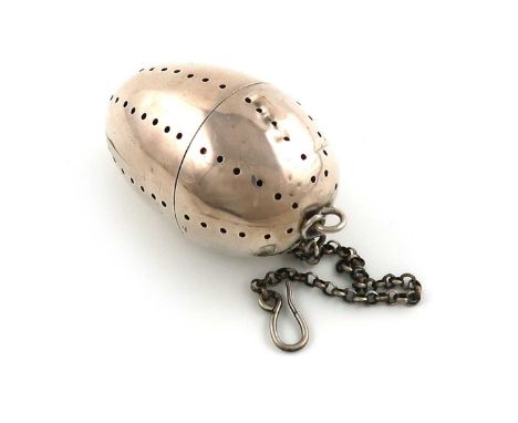 A Victorian silver tea infuser, maker's mark partially worn, W?, London 1864, egg form, hinged cover, with a chain and clip, 