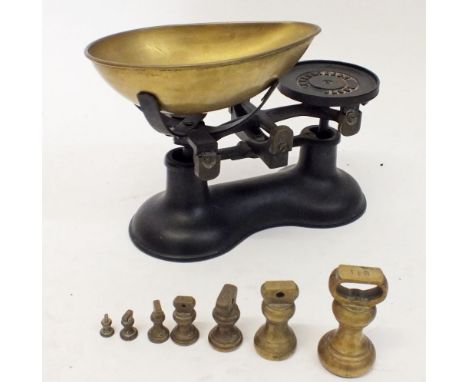 A Boots cast iron and brass set of scales and weights 