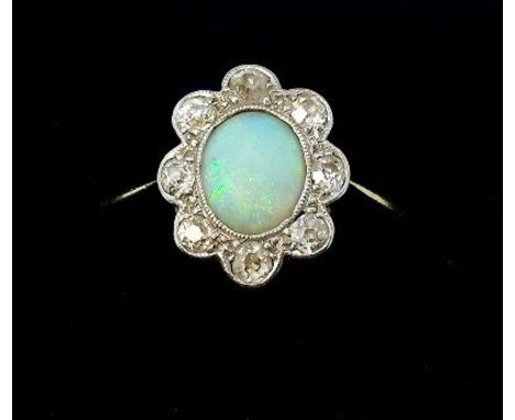 An 18 carat gold and platinum opal and diamond set cluster ring, 2.5g, size M 