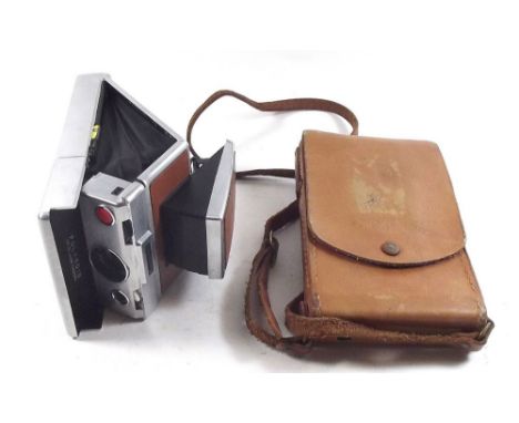 A Polaroid SX70 land camera, cased 