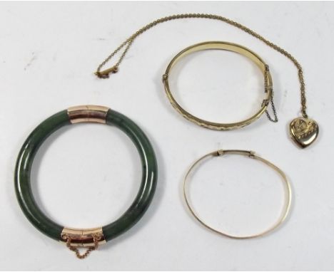 Two rolled gold hinged bangles, a jade hinged bangle and a rolled gold heart pendant 