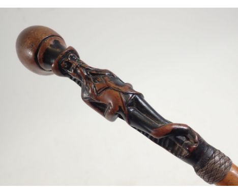 An early 19th century walking stick finely carved with the head of a bearded man 