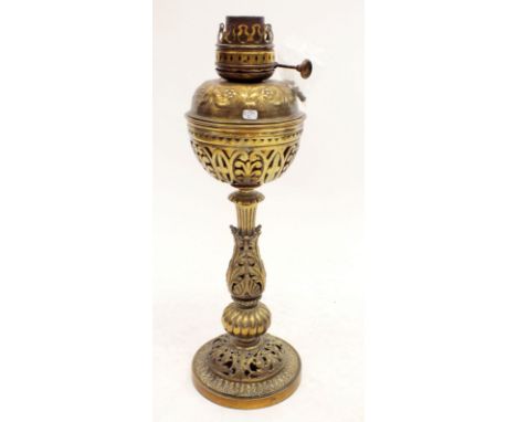 A Victorian brass oil lamp with pierced and embossed decoration, 52cm tall