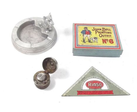 An aluminium ashtray with Scottie dog to rim, a Rinso advertising set square, a John Bull printing set and a naval travelling