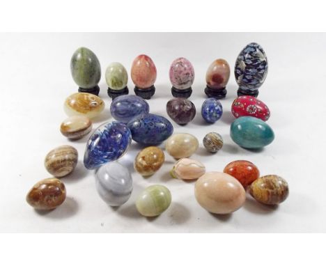 A collection of stone and cloisonné enamel eggs 