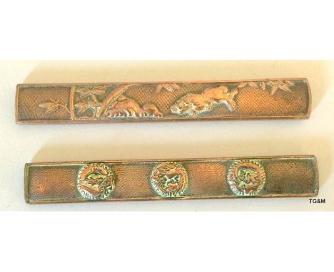 Two Japanese bronze knife handles, 9cm long