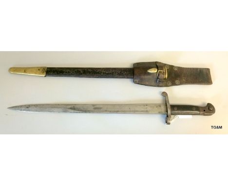 A British Pattern 1887 Sword Bayonet for the Martini Henry rifle in its leather scabbard with brass mounts and with its leath