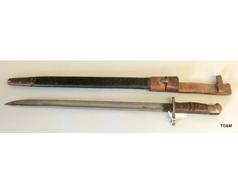 An American bayonet in its leather scabbard with metal mounts and original leather frog. Makers name to blade Remington 1913 