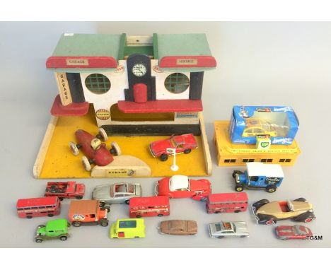 A collection of Corgi and diecast cars with a wooden garage