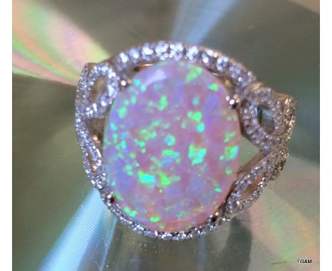 A silver and CZ dress ring with a large central Opal