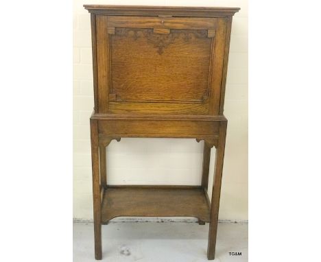 An oak cabinet with drop down door and a fitted shelf underneath 115x60x35cm
