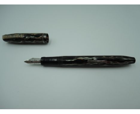 An Arnold fountain pen, circa 1949, silver, bronze and grey wave, fine nib, lever fill in good condition, made in the USA