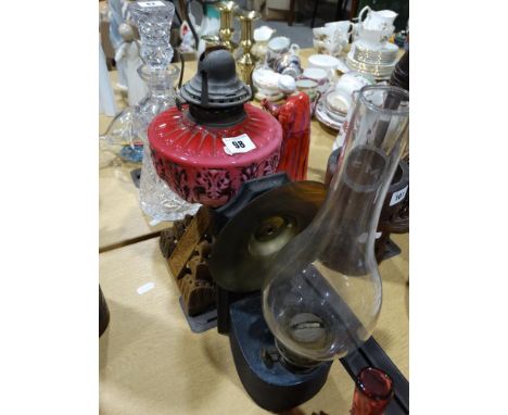 A Square Based Metallic Oil Lamp With Pink Glass Reservoir Together With A Further Bedroom Oil Lamp