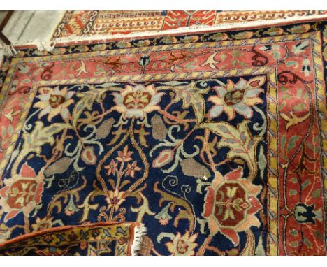     A Blue &amp; Red Ground Floral Patterned Carpet With Tassel Borders, 106 X 74"      