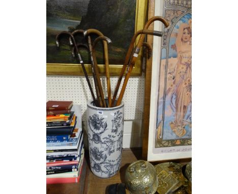     A Group Of Eight Silver Banded Vintage Walking Canes Within A Pottery Stick Stand                                        