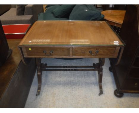 A reproduction mahogany drop-leaf sofa table in the Regency style, the cross-banded top with reeded edge above two drawers wi