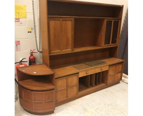 A Nathan teak lounge unit, 183 cm wide x 46 cm deep x 183 cm high, together with two dwarf cabinets, a dwarf corner cabinet, 