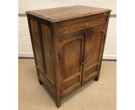 A 19th Century Indian teak cupboard, the plain top above a parquetry inlaid frieze and two cupboard doors enclosing a shelf a