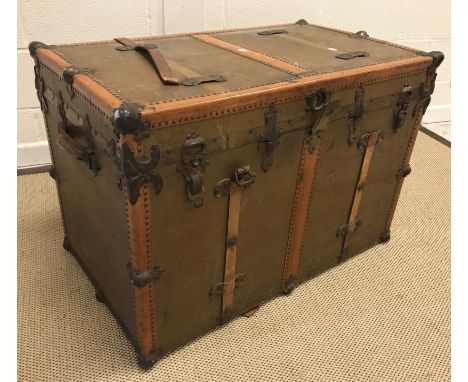 A circa 1900 Drucker trunk, painted canvas covered with studded leather and metal embellishments and fitted interior bearing 