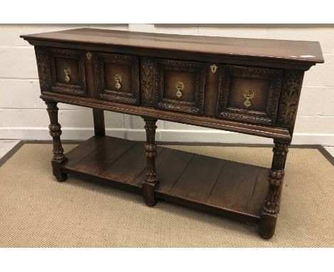 A 20th Century oak dresser in the 17th Century style, the plain top above two drawers on turned and carved stop fluted waiste