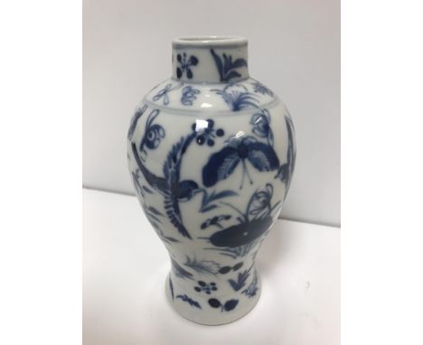 A 19th Century Kangxi baluster vase with blue and white floral spray and bird decoration, bears four mark character mark to b