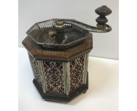 An unusual early 20th Century coffee grinder of octagonal form with mahogany and inlaid top and base and pierced metal sides 