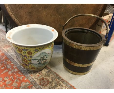 An oak bucket with brass coopered rings and swing handle, 31 cm high excluding handle x 32 cm diameter, together with a moder