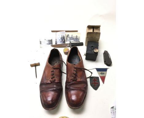 A collection of Free French clandestine SOE secret agent items including shoes with a hidden compass compartment, knife, tin 