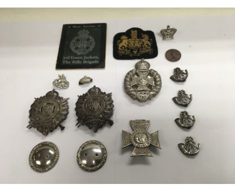 A collection of military badges to include badges for lancer dispatch pouche plates. One marked Sterling silver and two more 