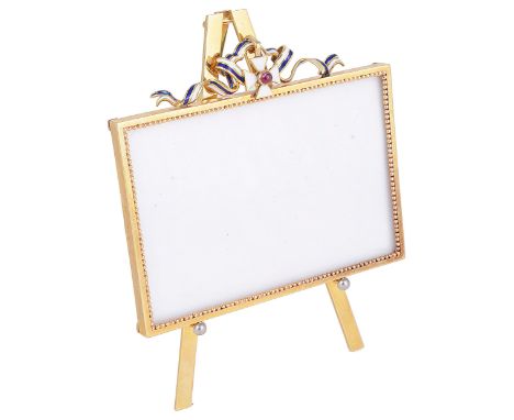 A GREEK GOLD SMALL FRAME ON STAND  VOURAKIS  ATHENS  CIRCA 1930 the rectangular frame with beaded inner border surmounted by 