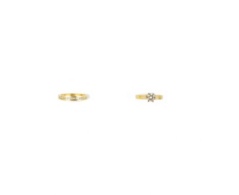 DIAMOND RING  the brilliant-cut diamond in a claw setting; together with a band ring channel-set with eleven brilliant-cut di