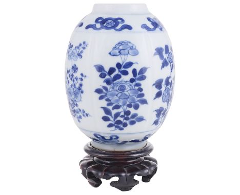 A CHINESE BLUE AND WHITE PORCELAIN VASE KANGXI (1662-1722) ovoid painted between moulded flutes with flowers bordered by band