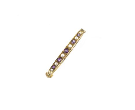 NINE CARAT GOLD  AMETHYST AND PEARL BANGLE  1970s the hinged bangle set to the front with graduated circular amethysts and ha