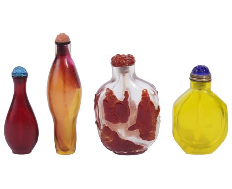 A STUDY COLLECTION OF FOUR CHINESE GLASS SNUFF BOTTLES comprising: a red overlay clear glass ‘scholars’ bottle  with a red gl