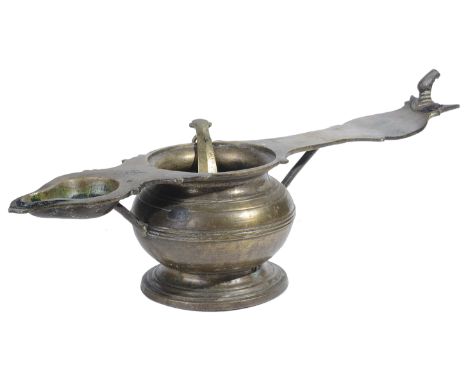 A BRASS RITUAL OIL LAMP  KERALA  SOUTH INDIA  19TH CENTURY of elongated form  the squat turned oil reservoir with ladle attac