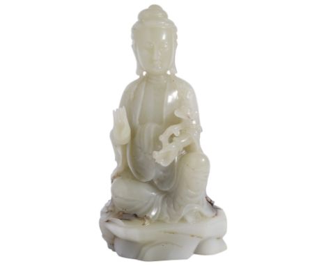 A LARGE CHINESE PALE CELADON JADE FIGURE OF GUANYIN carved kneeling on an oval rockwork base  wearing a long flowing robe ope