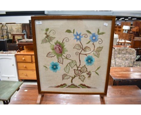 An early 20th Century embroidered fire screen