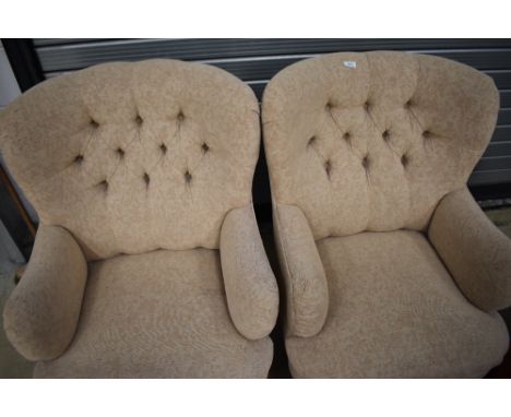 A pair of modern button back armchairs