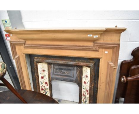 A Victorian style cast , tiled and stripped wood fire surround.
141cm wide overall by 129cm tall