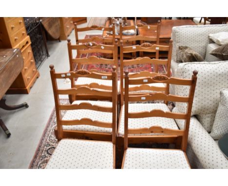A set of six modern pine ladder back dining chairs having overstuffed seats