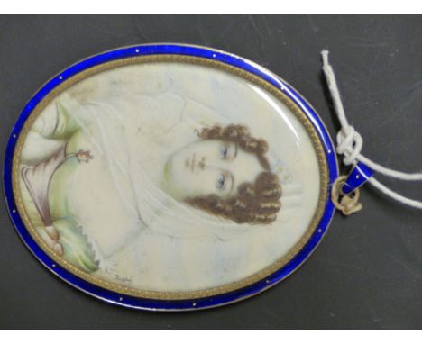 A GILT AND  ENAMEL FRAMED OVAL PORTRAIT MINIATURE OF A LADY