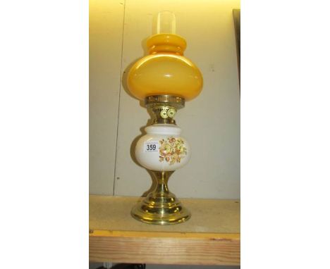 A ceramic and glass oil lamp with brass effect base, circa 1980's