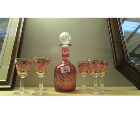 A cut glass overlaid ruby decanter and 6 glasses