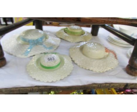 Four ceramic wall bonnets.